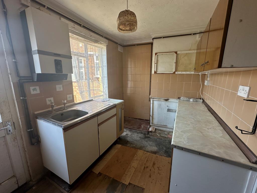 Lot: 155 - END-TERRACE HOUSE FOR REFURBISHMENT - Kitchen with access to garden